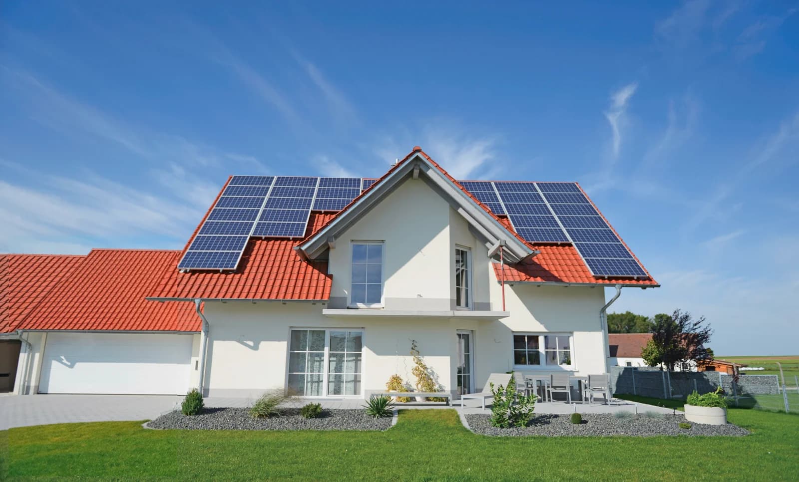 A home with rooftop solar panels capturing energy from the sun